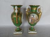 two green vases with gold and white designs on them