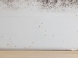 a picture of a moldy wall in the corner of a room