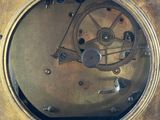 a gold clock that is sitting on top of a table