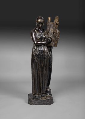 une statue en bronze représentant une femme tenant une harpe