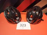 two helmets are sitting on a table with a price tag