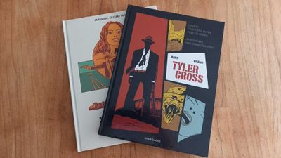 two books that are sitting on a wooden table