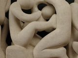 a sculpture of a group of people sitting on a table