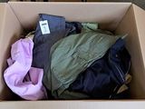 a box full of clothes that is sitting on the floor