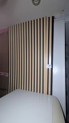 a bed in a room with a striped wall behind it