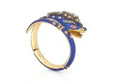 a close up of a gold ring with blue enamel and diamonds