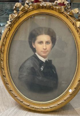 an old picture of a woman in a black dress in a gold frame