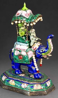 an image of a figurine of a man riding an elephant