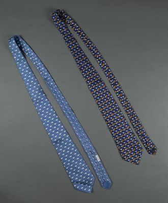 two ties are laying next to each other on a table