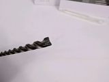 a person using a drill to drill a piece of metal