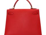 a red leather handbag on a white background