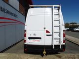 the back of a white van parked in front of a building