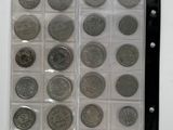 a lot of coins that are in a plastic case