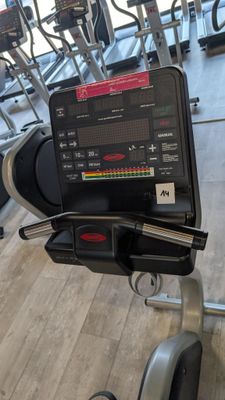 a laptop on a stationary exercise bike in a gym
