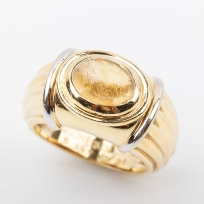 an image of a gold ring with a stone in the center