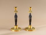 pair of antique brass candlesticks with figurines on bases