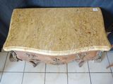 a wooden table with a marble top on a tile floor