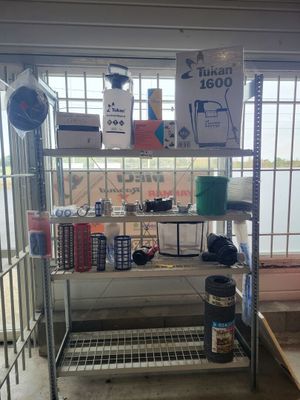 a metal shelf with various items on it in a room