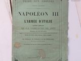 an old book sitting on top of a table next to a pile of papers
