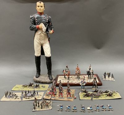 a figurine of a man standing in front of a bunch of toy soldiers