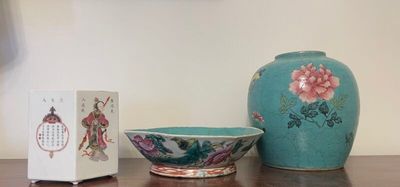 a vase and a bowl sitting on a table next to a box