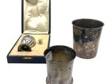 three silverware items including a flaskt, a cup, and a box
