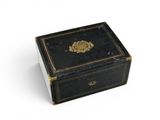 a small black box with a gold decoration on it
