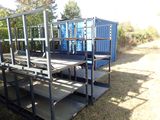 a blue container sitting on the ground next to a set of stairs