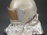 an old helmet is sitting on a piece of cloth