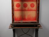 an old wooden cabinet with a red and gold design on it