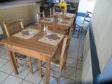 tables and chairs are lined up in a small restaurant
