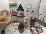 a table with a lot of items on it that include a doll house, a candle, a candle holder, and other items