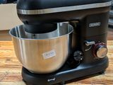 a black mixer sitting on top of a wooden table