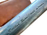 a close up of a baseball bat with a leather case