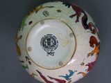 a white bowl with colorful designs on it on a table
