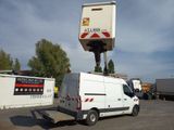 a white van parked in a parking lot with a crane on top of it