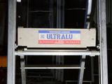 a sign that reads ultraallu on the side of a building