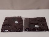 two bags of chocolate colored paper sitting on top of a white table
