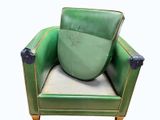 a green leather chair with a green cushion on it