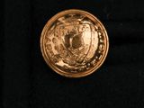 a close up of a gold coin on a black cloth