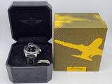 an image of a watch in a black box with a yellow airplane