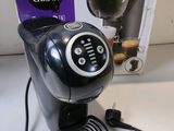 a black coffee maker sitting on a counter next to a box of coffee