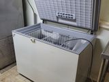 a white chest freezer sitting in the corner of a room