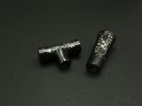 two black and silver objects on a black surface