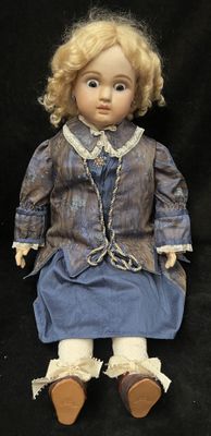 a doll that is sitting on a black surface