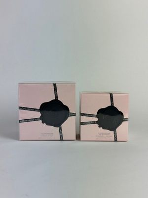 two boxes with a pair of black glasses on them on a white surface