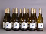 six bottles of white wine lined up in a row