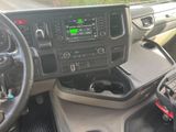 a dashboard of a truck with a steering wheel and dashboard controls