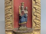 an image of a statue of a woman holding a candle in a gold frame