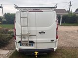 a white van with a ladder on the back of it